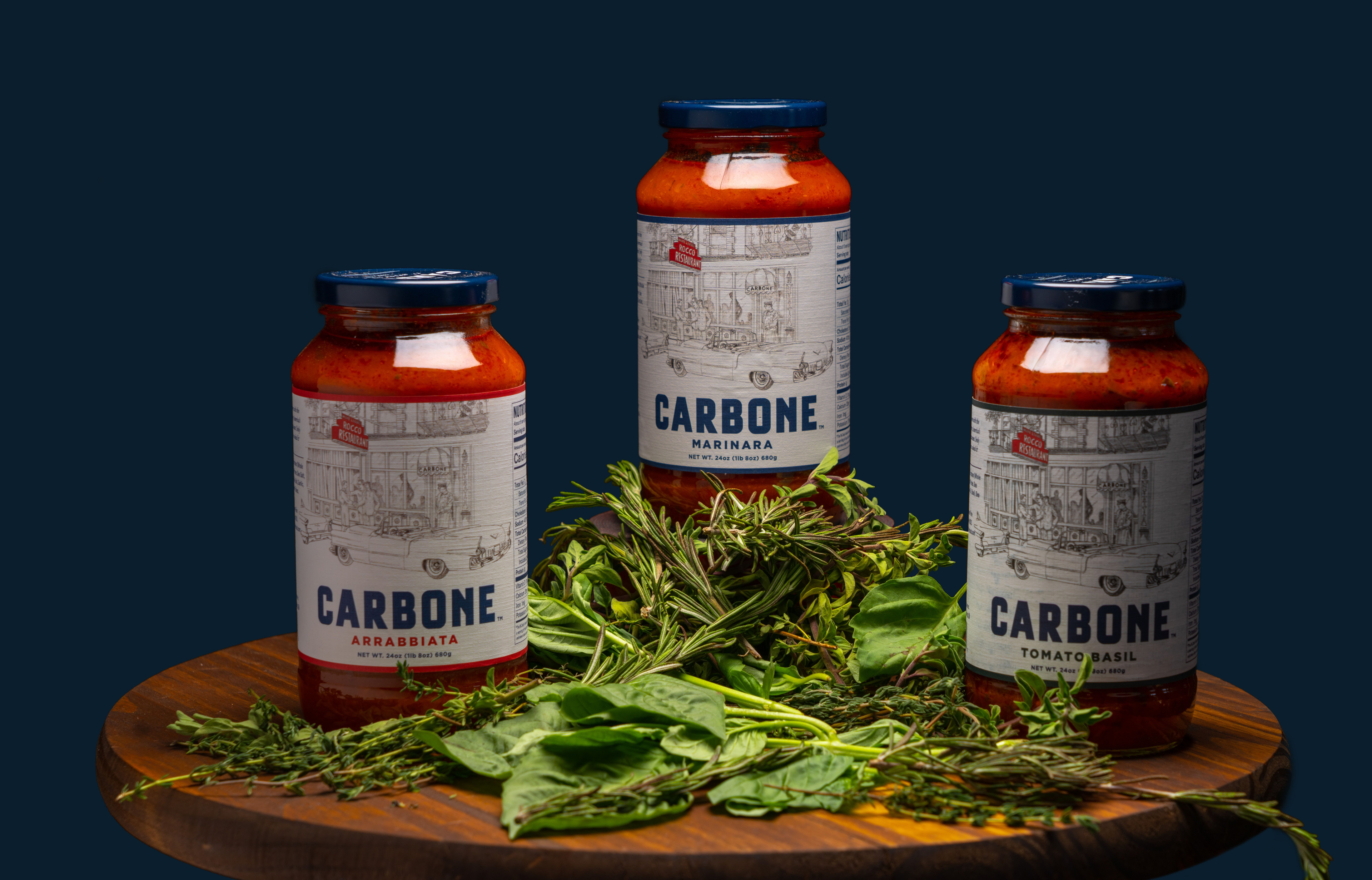 Product shot of 3 carbone sauces lined up in front of a blue background.